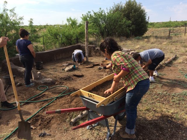 In this photo, Rebecca Renteria, director of LHHTA, screens soil for mixing into mud.
