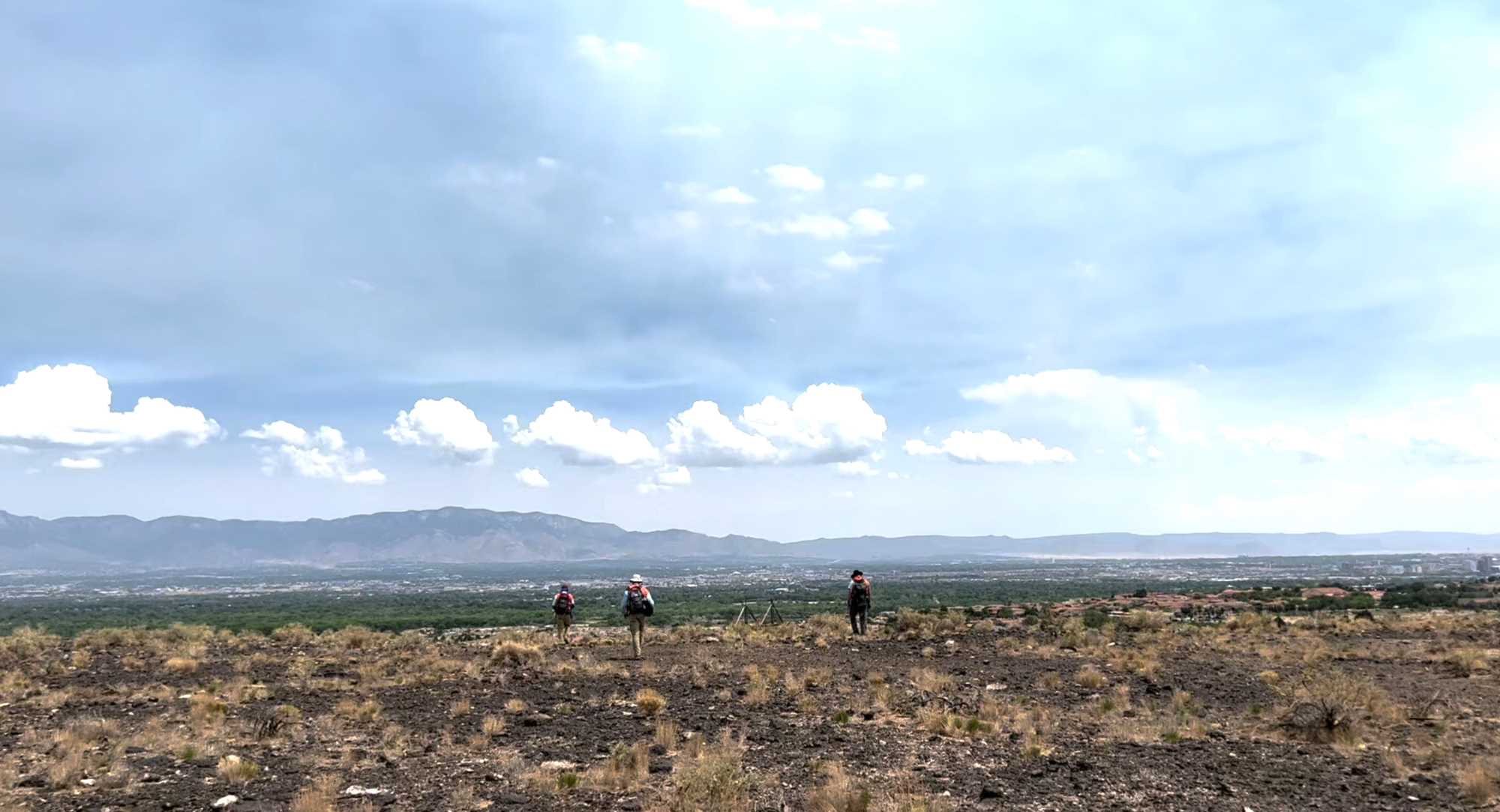 View to the east, showing the Archaeology Southwest crew conducting reconnaissance work on the Petroglyph National Monument.