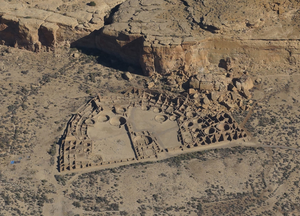 Aerial view of Pueblo Bonito, most impressive site in Chaco Canyon, and, perhaps in the continental USA. The site was built beginning in the early 800s and used until the late 1200s, serving as the ceremonial center of the ancient Pueblo world for much of the time. Click to enlarge. Image: Paul F. Reed