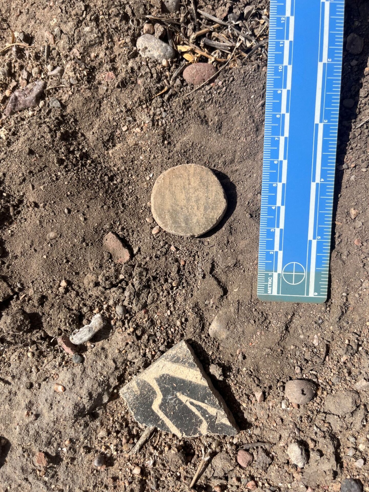 A sherd that someone had ground to form a circle–maybe a game piece?