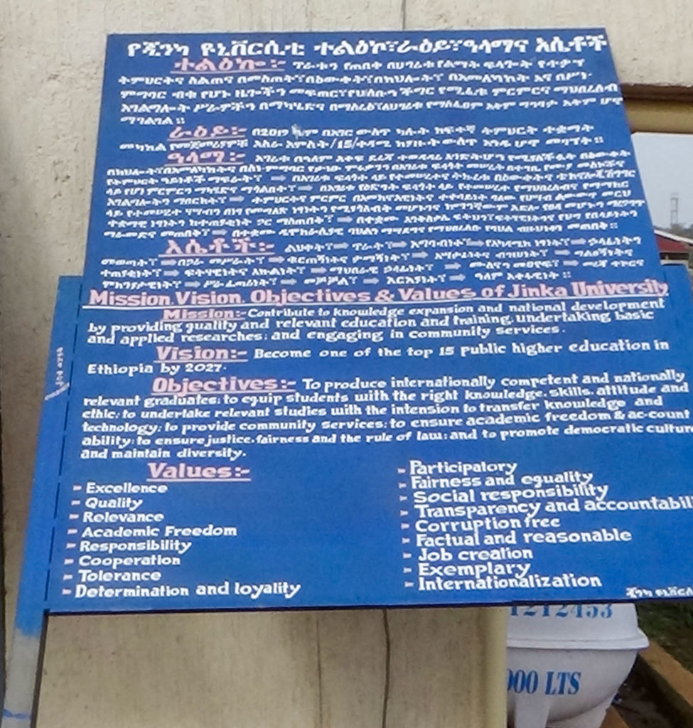 Jinka University’s Mission, Vision… presented in Amharic and English on a sign ready for planting next to the administration building. Image: J.R. Welch