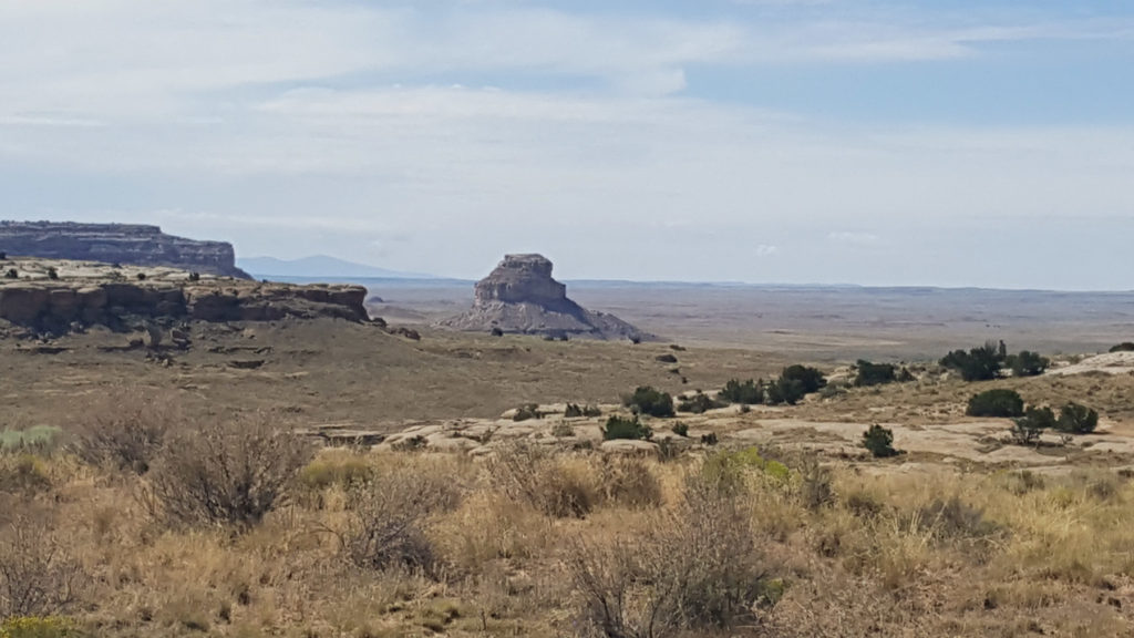 View south to Fajada Butte in Chaco Canyon, from the mesa above. On the distant horizon to the left of Fajada lies Mt. Taylor, held sacred by Pueblo people. Image: Paul F. Reed