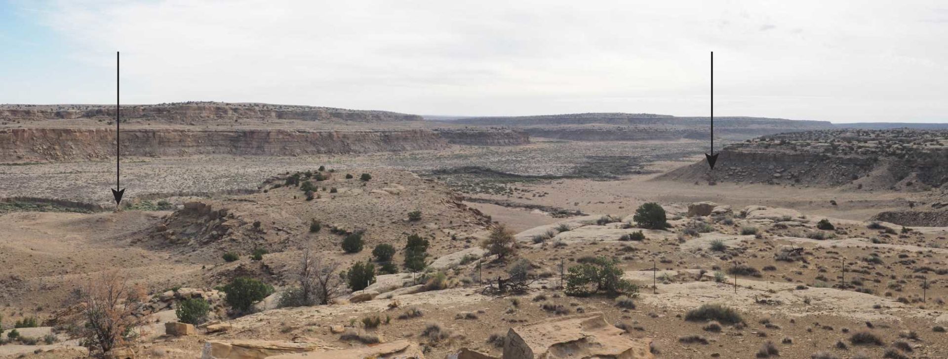 View from the Chacra Fortress pueblito (LA 52606) showing two additional pueblitos, one hilltop and one bouldertop, located less than 1 kilometer away on Navajo Nation land (indicated by arrows). Image: Wade Campbell