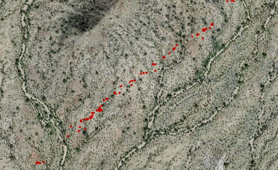 A line of artifacts (red dots) traces an Indigenous trail through the Maricopa Mountains.