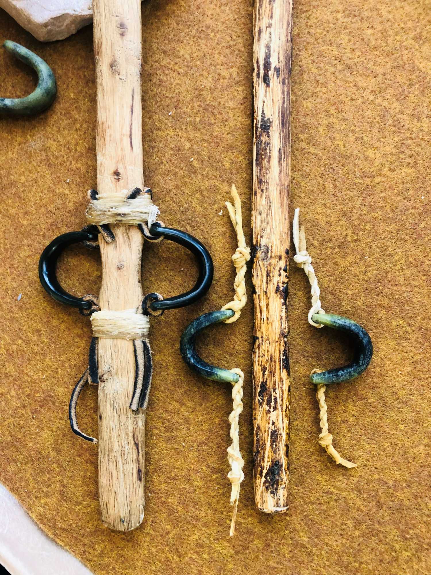 These are replicas I made showing how the stone loops may have been hafted onto the atlatl.