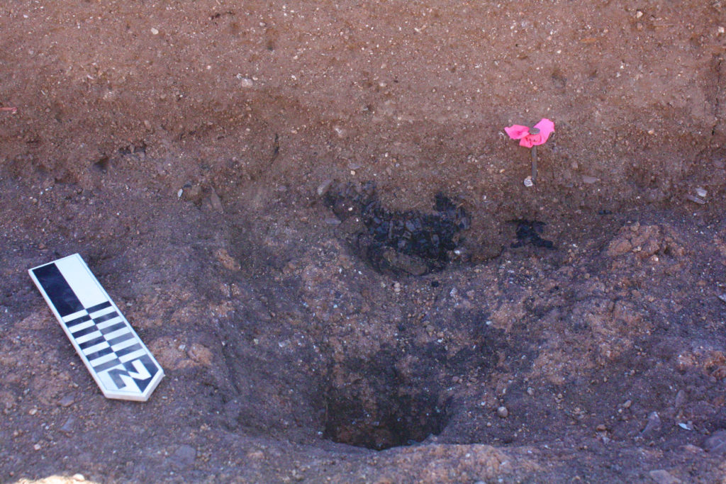 A shallow posthole with the remains of a very charred post were found near the centerline of the ballcourt.