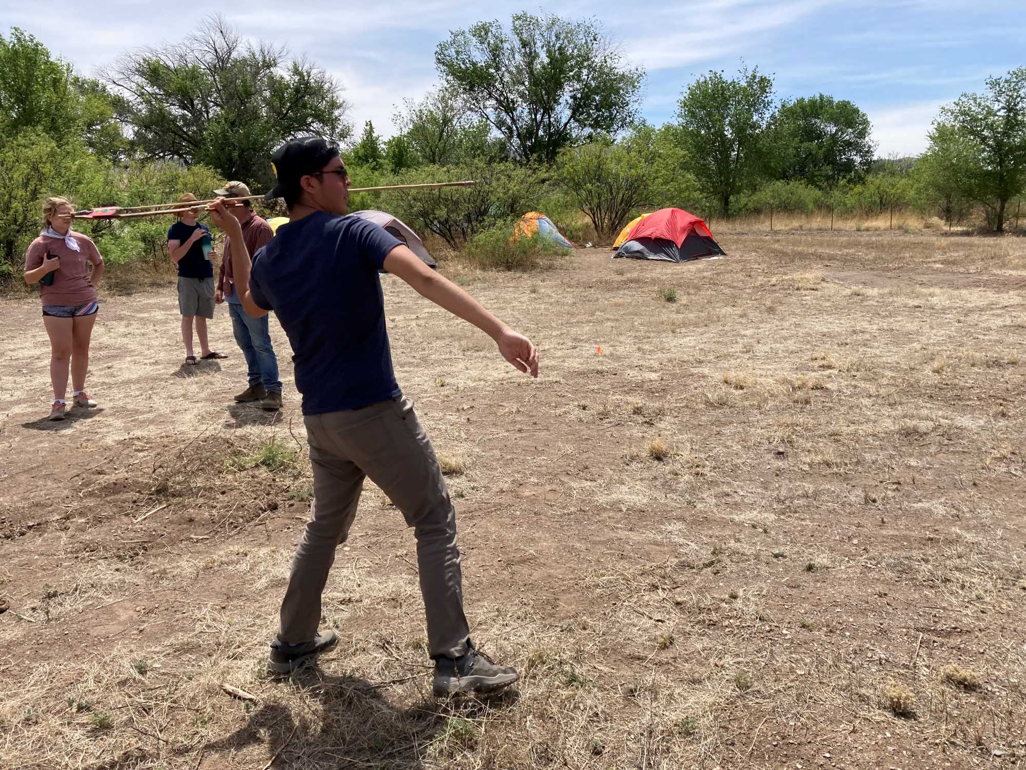 University of Arizona undergraduate Totsoni Willeto tries out the atlatl on our first evening in camp in Cliff, NM.
