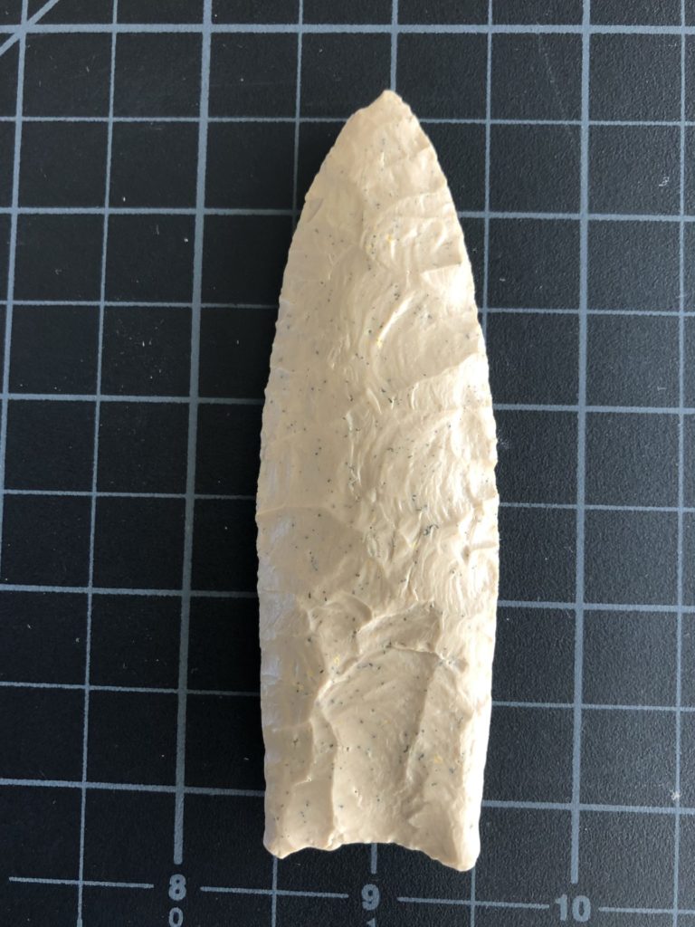 This Clovis point from Naco, Arizona, is quite thick. It has extensive pressure flaking across its surfaces. This seems common among points found at the Naco, Murray Springs, and Lehner mammoth kill sites. These sites are all from the same area along the San Pedro River in southern Arizona. It is likely they are all from a single group of hunters utilizing this area for a period of time, probably hunting the last herds of mammoths in the area.