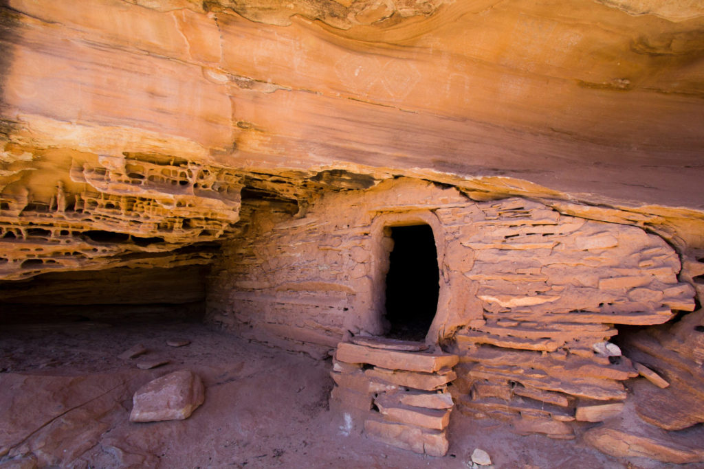 Upon close inspection, one can see white pictographs placed above this carefully fitted Ancestral Puebloan structure. © Jonathan Bailey
