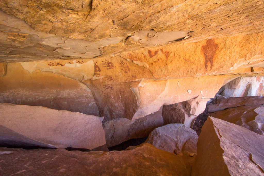 Handprints and human figure, Ancestral Pueblo pictographs. © Jonathan Bailey