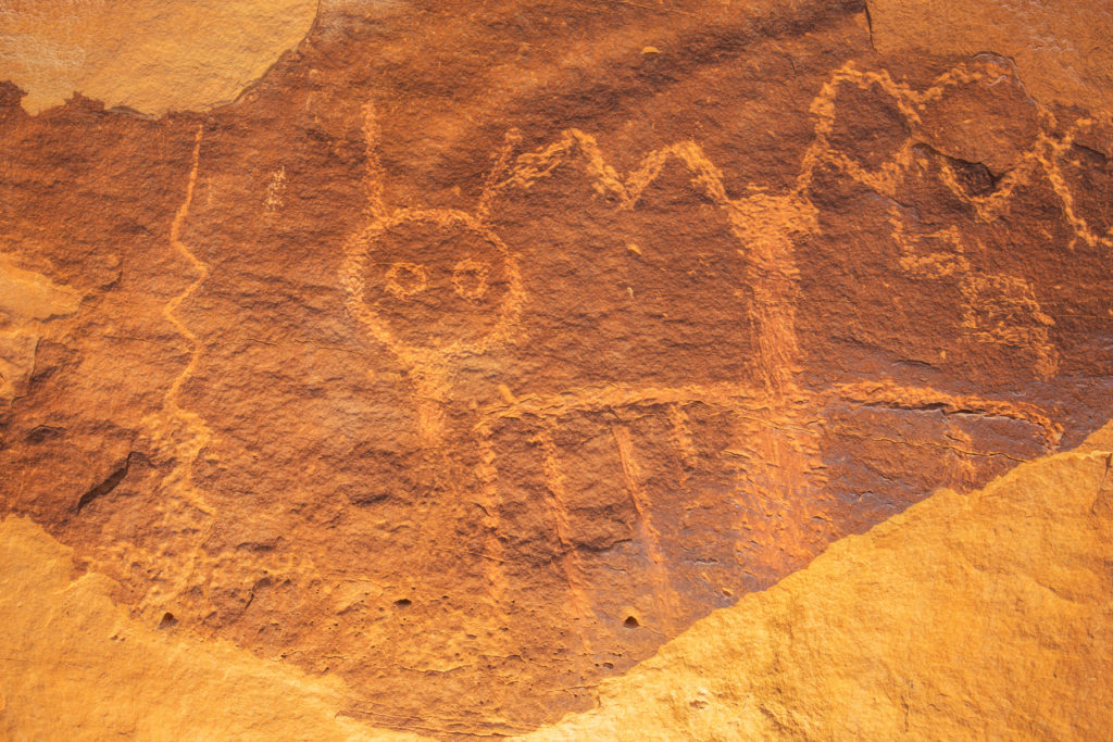 These arresting Glen Canyon Linear style petroglyphs are carved low on a cliff wall in the former boundaries of the Bears Ears National Monument. © Jonathan Bailey