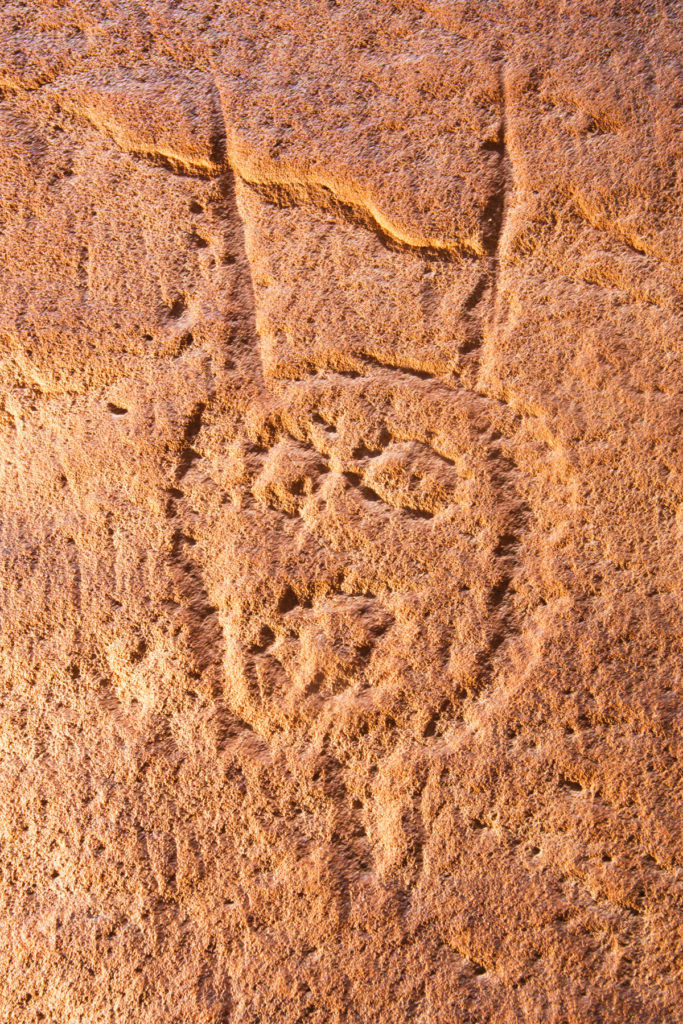 Attributed to Glen Canyon Linear Style, these haunting faces adorn the high cliffs of the San Juan River. © Jonathan Bailey