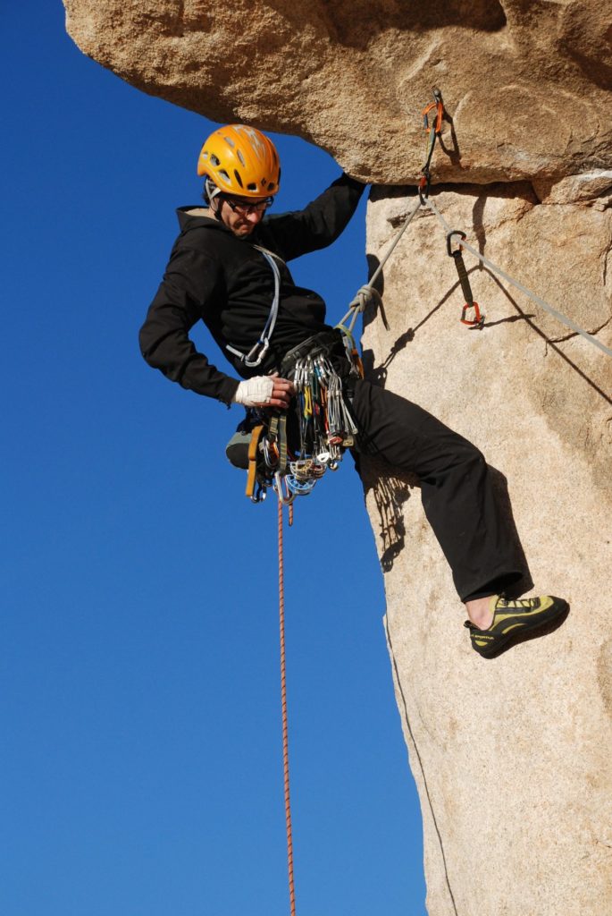 Rock Climber Using Bolts