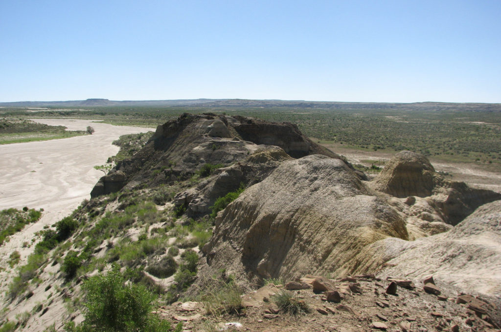 View of the Greater Chaco Landscape at the Bis sa’ani great house. View is to the east, with Escavada Wash on the left and the great house on the eroded mesita in the center of the photo. Image: Paul F. Reed