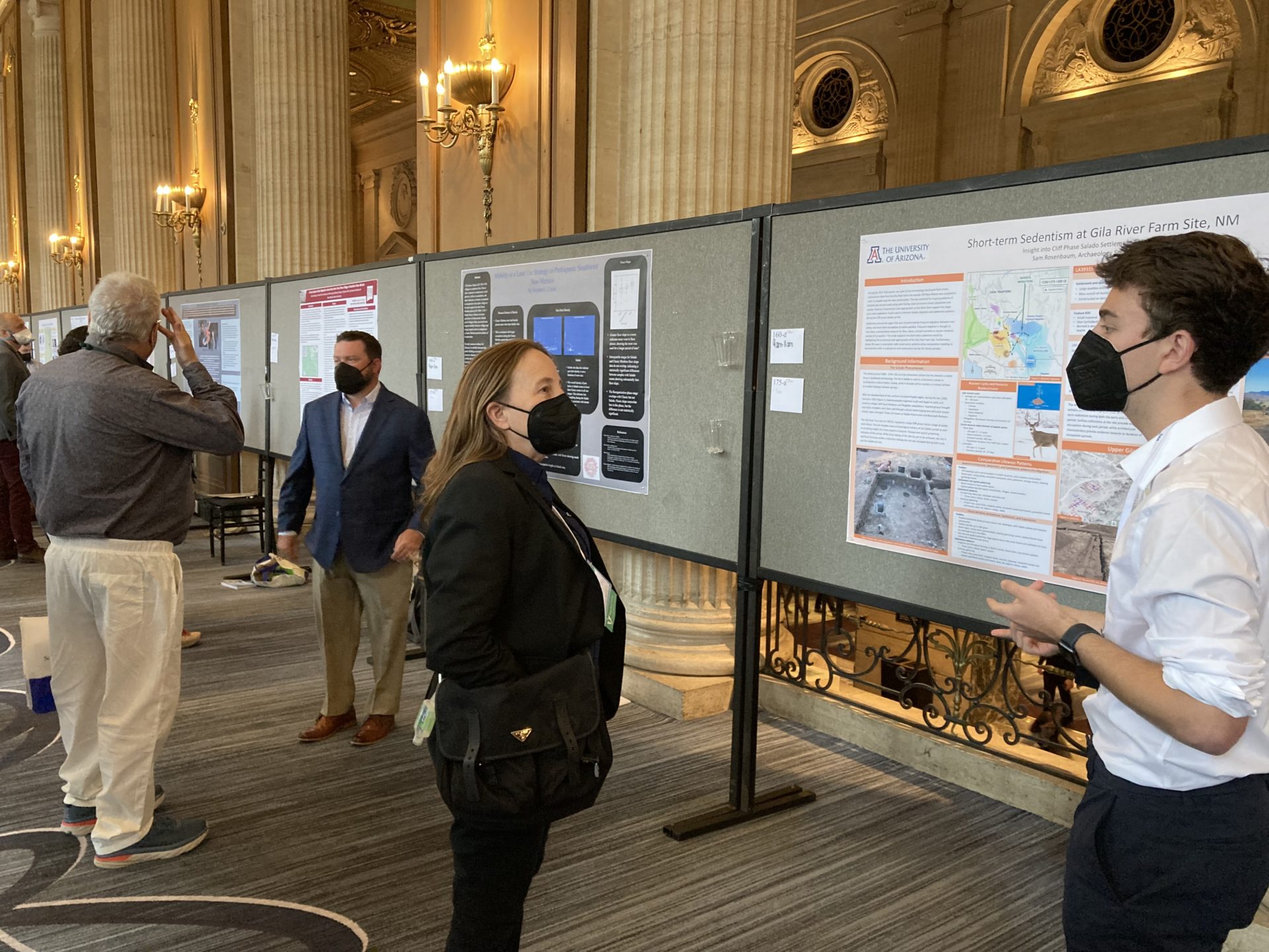 Sam Rosenbaum (right) and Stephen Uzzle (in sportcoat) discuss their research in our Mogollon area poster session.
