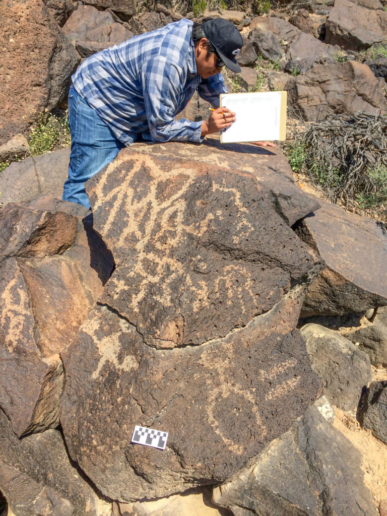 Skylar documenting petroglyphs