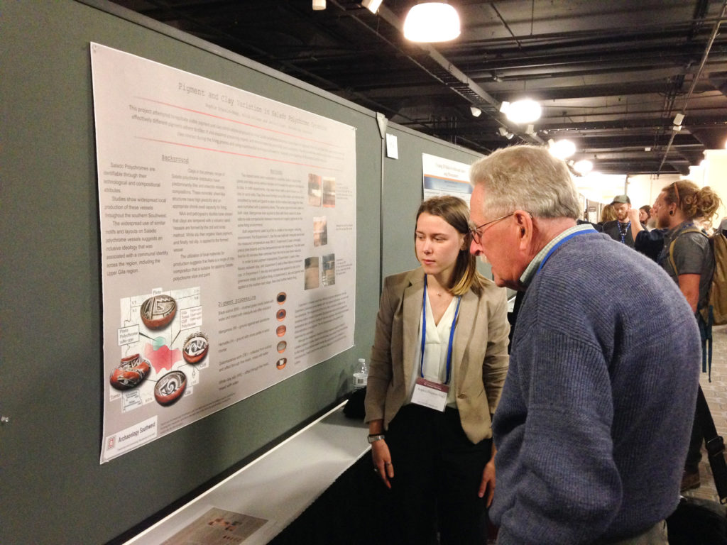 2017 field school student Sophia Draznin-Nagy discusses her research on experiments with clay and pigments used in Salado polychrome pottery with a conference attendee.