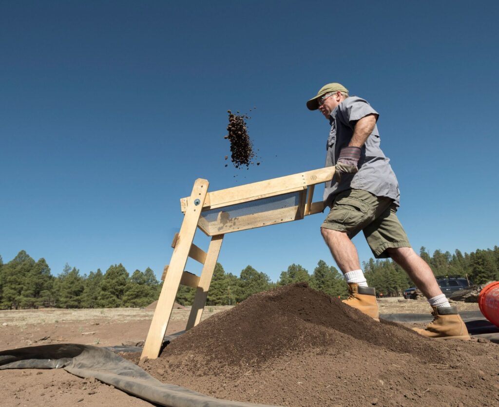 Me screening backdirt in Reserve, New Mexico. Image: Rick Wicker, courtesy of the Denver Museum of Nature and Science
