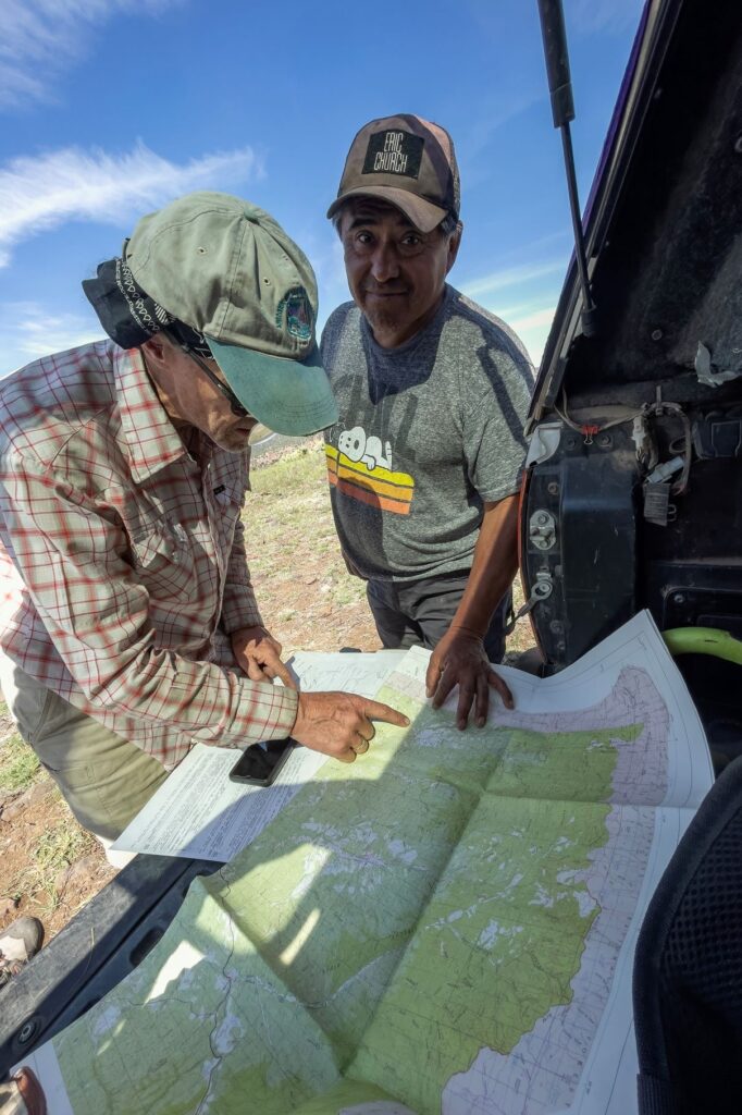 Co-management expert Gregg Henry wondering why John Welch still needs a map to follow Indigenous trails on the West End of White Mountain Apache Tribe lands, May 2023. Image: Courtesy of Bill Hatcher