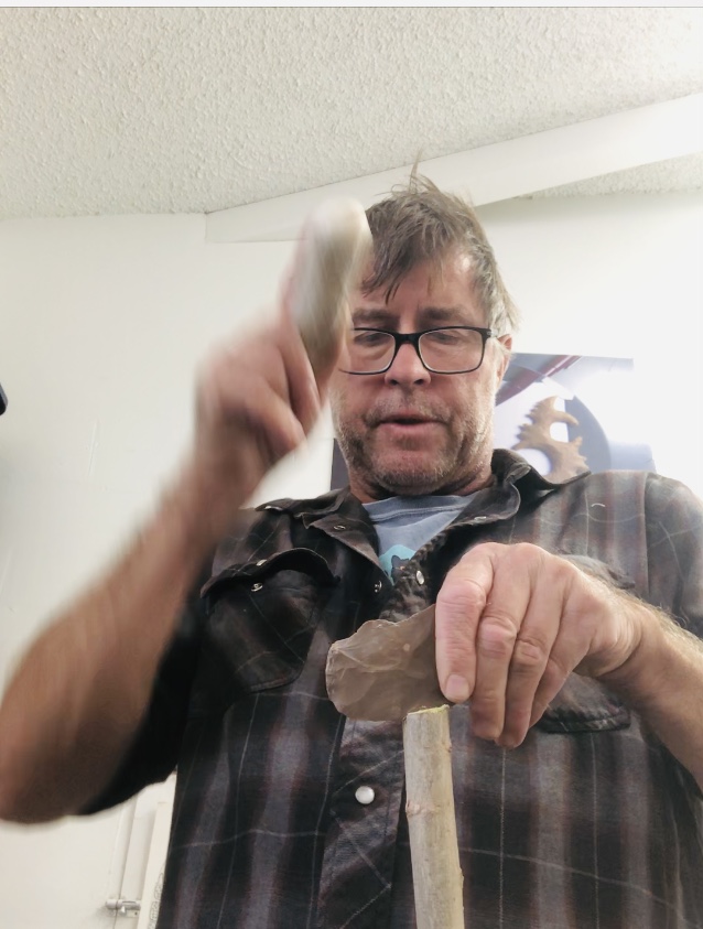 I split a desert willow branch with a sharp flake, using one of my flintknapping tools as a hammer. I like to do the when the wood is still green, as it is more pliable for creating the haft and bending over the saw blade.