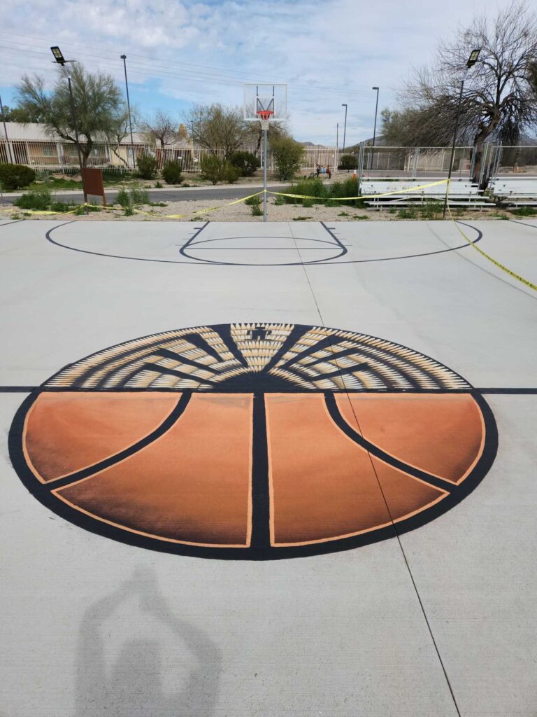 Cortez’s work on a basketball court. The top of the ball is an O’odham basket with O’odham “man in the maze” symbolism.