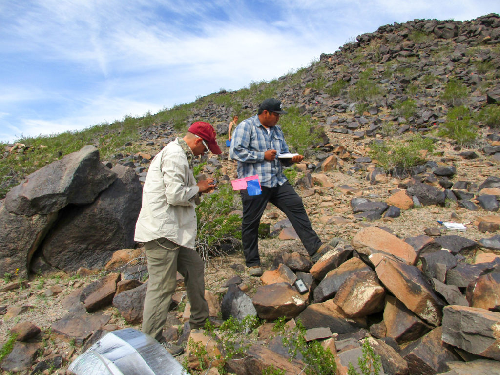 Aaron Wright (at left), Skylar Begay (at right), and Nathalie Brusgaard (in background) documenting petroglyphs along the lower Gila River. Image: Jaye Smith