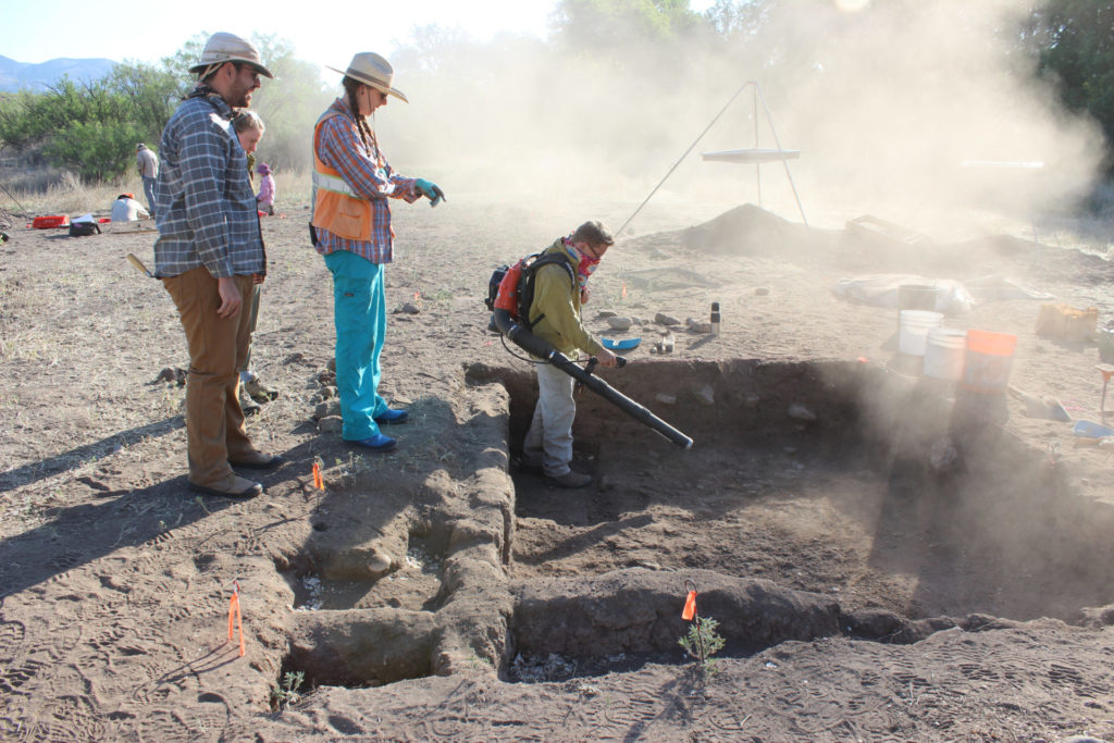 Our Archaeology Southwest field school is investigating how new northern traditions merged with existing Mogollon ones in the upper Gila in the late AD 1200s, using a mix of techniques used by archaeologists working in different regions today. Here, instructors Evan Giomi, Stacy Ryan, and Leslie Aragon provide plenty of supervision to former student Matt Steber, who’s using a leafblower to expose adobe architecture like a Hohokam area archaeologist while our legacy screens from the 1970s Mimbres Foundation excavations loom in the background. (Matt is now a professional archaeologist in Phoenix, so something must have stuck!)