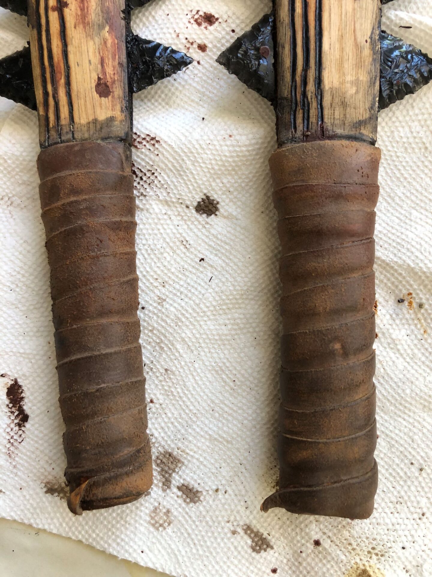 I wrapped the hilts with buckskin and dirtied them up. They looked like old tennis racquet handles!