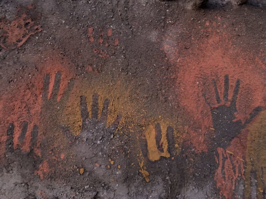 Outlines of hands against spit paint